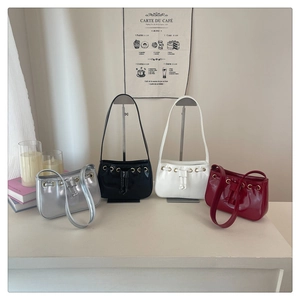 Selection of glossy underarm bags in silver black white and red with drawstring details