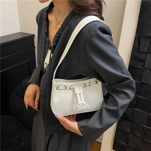 Minimalist white faux leather underarm bag with drawstring and gold eyelets
