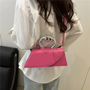 Minimalist fuchsia trapezoid handbag with unique silver asymmetric metal handle and strap