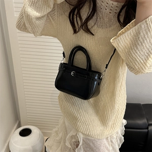 Elegant black patent leather mini handbag with top handles and adjustable shoulder strap
