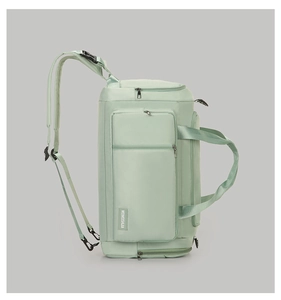 Detail of mint green fitness bag showing waterproof fabric and durable side handles
