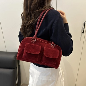 Chic burgundy suede handbag with dual front flap pockets for stylish shoulder wear