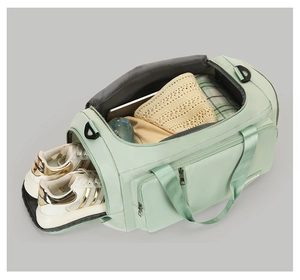 Detail of mint green fitness bag showing the separate ventilated shoe compartment