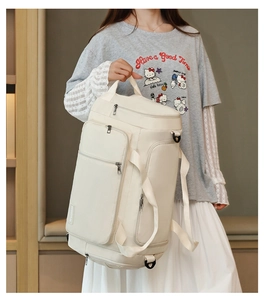 Detailed side view of the beige sports bag featuring separate shoe compartment and D-ring hooks