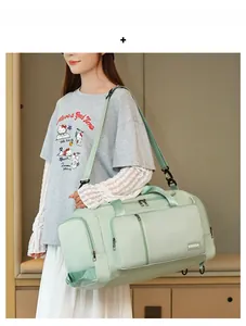 Detail of mint green travel bag featuring waterproof fabric and adjustable shoulder strap