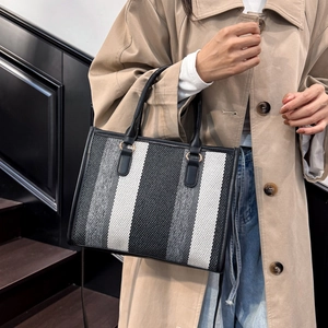 Chic tricolor striped woven tote bag with leather handles and long shoulder strap