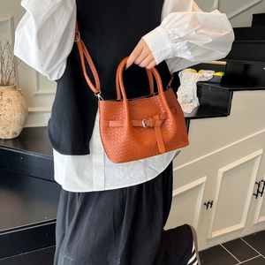 Orange woven leather handbag with silver buckle detail and detachable shoulder strap