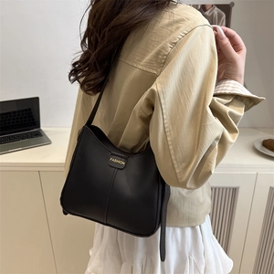 Minimalist black leather shoulder bag with gold 'FASHION' buckle for chic daily office wear