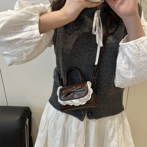 Mini brown PU leather crossbody bag featuring elegant white lace edges and a bow detail