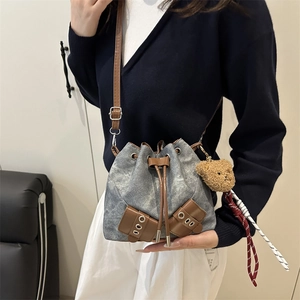 Chic washed denim bucket bag in grey with brown leather trim and cute bear charm