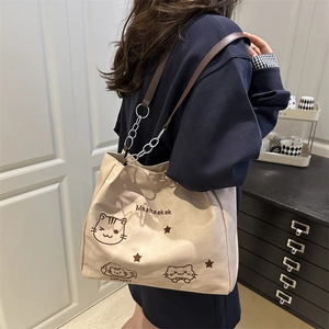 Fashionable beige canvas tote bag with cute cat embroidery and brown leather chain strap