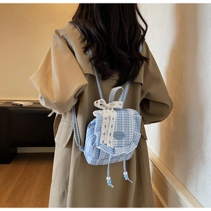 Detailed view of light blue checkered mini backpack with lace bow and ruffle trim decoration