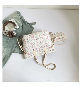 Detail of quilted tote bag with cute floral bear print next to lifestyle props