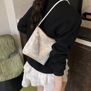Minimalist tote bag with gold mountain embroidery and long silver tassels on ivory satin