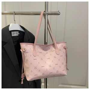 Detail of pink lychee leather tote bag with LNBOE patterns and drawstring side accents