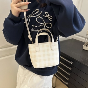 Plaid mini crossbody bucket bag in beige and white with adjustable shoulder strap