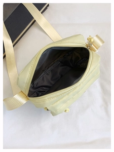 Interior view of yellow nylon crossbody bag with zipper closure and dark grey lining