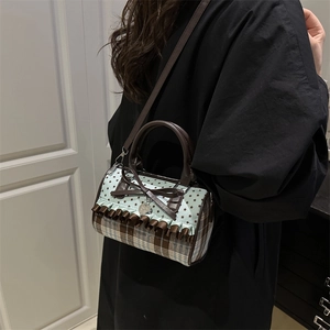 Sweet bow Boston bag with blue star print and brown plaid patterns in street style