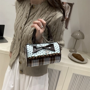 Retro bow pleated shoulder bag with star pattern and ruffle trim in lifestyle scene