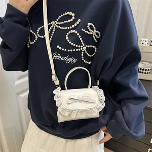 Mini white leather crossbody bag with elegant lace edges and a sweet bow decoration
