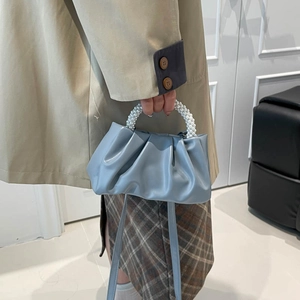 Light blue ruched handbag with white pearl handle and thin adjustable shoulder strap