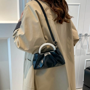 Chic ruched pearl handle black PU leather shoulder bag for women worn with a trench coat