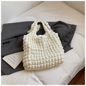 Close-up of white puff cloud texture and fabric handles on minimalist shoulder tote bag