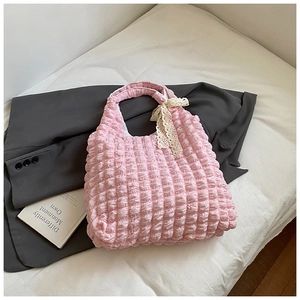 Detailed texture of pink puff wrinkled canvas tote bag with white lace bow decoration