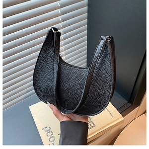 Close-up of black crescent shoulder bag featuring high-quality lychee texture leather