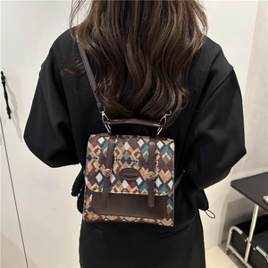 Retro geometric jacquard backpack with brown leather flap and stylish metal logo