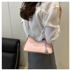 Detail of pink PU leather crescent bag with chunky silver chain and round pendant