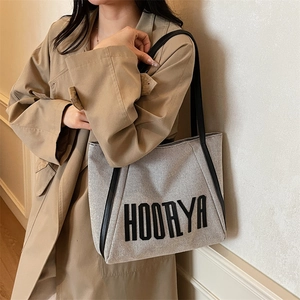 Large grey canvas tote bag with black leather straps and HOORYA print for work or school
