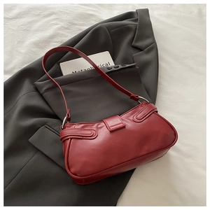 Deep red crescent underarm bag in smooth leather with silver metal buckles and strap