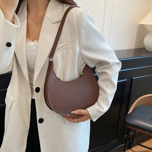 Chic brown lychee pattern leather crescent shoulder bag for women with modern minimalist style