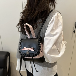 Pink and black lace floral mini backpack for women shown on model for size and style