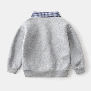 Detail of grey kids sweatshirt featuring a faux two-piece blue plaid shirt collar