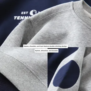 Detail of double-stitched seams and ribbed cuffs on a grey and navy boys' sweatshirt