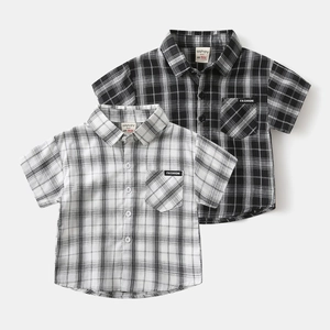 Detail of boys' checkered short-sleeve shirt with lapel collar and chest pocket