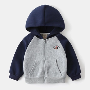 Detail of kids hooded jacket featuring cartoon dog embroidery and color-block design