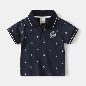 Detail of navy cotton polo shirt showing star prints and embroidered crown emblem