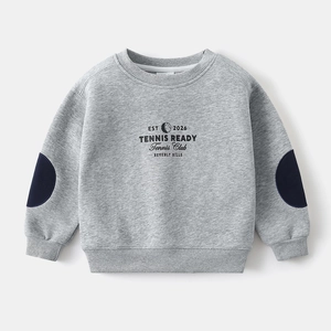 Close-up of gray cotton sweatshirt featuring tennis print and navy blue elbow patches