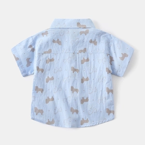 Detail view of boys' light blue shirt with grey pony prints and standard polo collar back