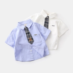 Detailed close-up of boys short sleeve shirts featuring plaid ties and fashion embroidery