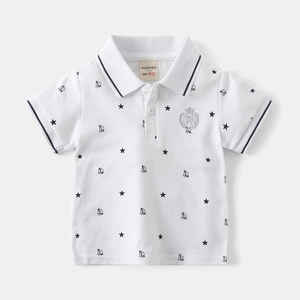 Detail of baby boy polo shirt featuring star and sailboat prints with embroidered badge