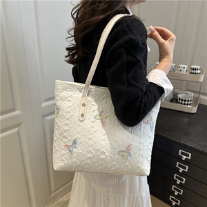Chic white quilted tote bag with colorful butterfly embroidery and twin shoulder straps