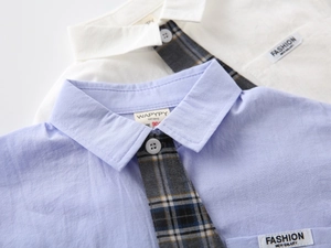 Close-up of boys short-sleeved shirts featuring polo collar and plaid tie embroidery details