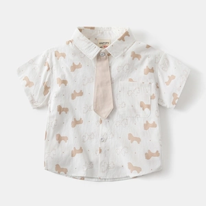 Close-up of boys' short-sleeved white shirt with brown horse print and matching necktie