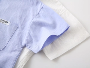 Detailed macro view of light purple cotton shirt fabric with FASHION label on chest pocket