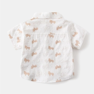 Detail of white cotton shirt featuring brown horse prints and standard collar for boys