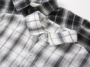 Detailed view of kids' plaid short sleeve shirts showing collar and fabric texture